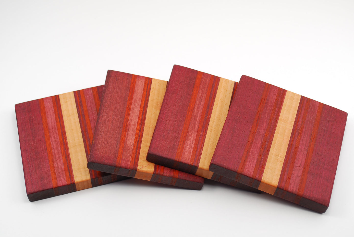 Set of 4 Coasters Made from Purple Heart, Paduk, Walnut and Maple Wood.